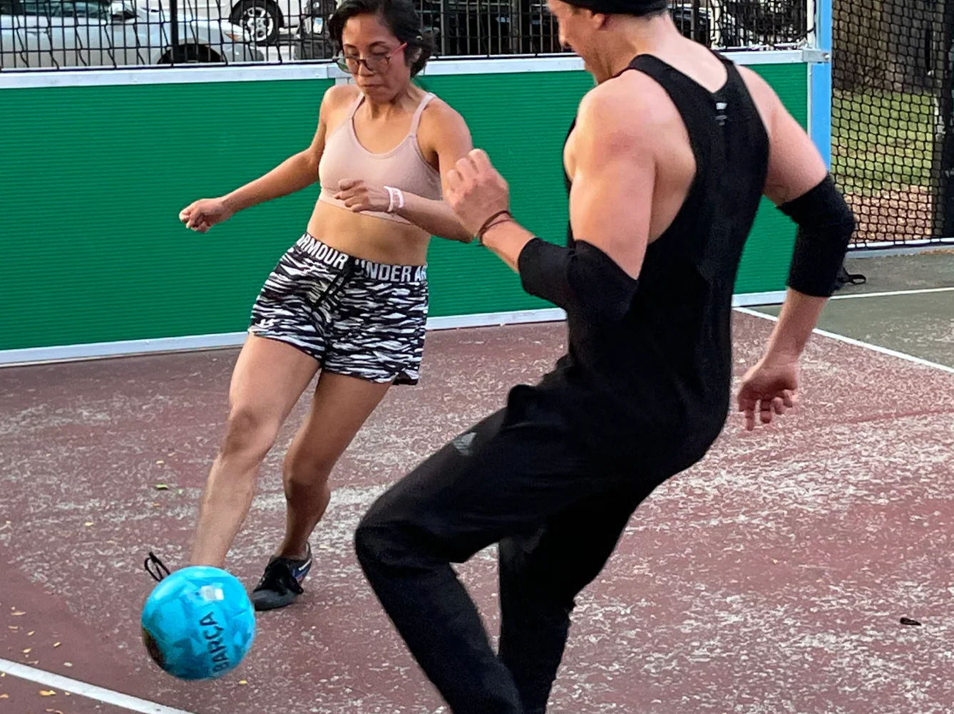 Adults playing drop-in street soccer